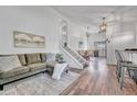 Inviting living room with hard wood floors, comfortable seating, and open floorplan at 4726 S Taft St, Morrison, CO 80465