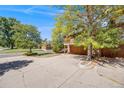 Exterior shot with a long drive way, a lush yard and mature trees surrounding the property at 1810 Youngfield Ct # A, Golden, CO 80401