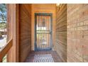 Close-up of the front door with decorative security door, and welcome mat, showing a charming entryway at 1810 Youngfield Ct # A, Golden, CO 80401