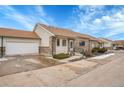 Single story brick home showcasing an attached two car garage, front yard and concrete driveway at 2616 E Egbert St, Brighton, CO 80601