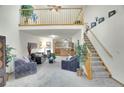 Bright living room features high ceilings, a staircase and open access to the adjacent kitchen at 2616 E Egbert St, Brighton, CO 80601