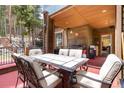 Comfortable seating for six on this outdoor deck with wood ceiling and exterior, ideal for dining al fresco at 167 Independence Cir, Breckenridge, CO 80424