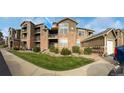 Condo building with balconies and green space. Great landscaping around the building and well maintained at 3035 Blue Sky Cir # 10-207, Erie, CO 80516