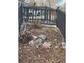 Landscaped front yard featuring decorative rocks, mulch, and a charming black fence at 1473 S Monaco S Pkwy, Denver, CO 80224