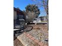 Landscaped front yard with charming statues, decorative rocks, and pathway to the front door at 1473 S Monaco S Pkwy, Denver, CO 80224