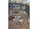 The property has a rock-mulched garden area featuring stone edging and a black fence at 1473 S Monaco S Pkwy, Denver, CO 80224