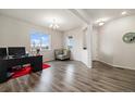Bright, open-concept living space with hardwood floors, large windows and a comfortable seating area at 10913 Ledges Rd, Parker, CO 80134