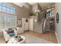 Inviting foyer features a staircase, hardwood floors, and plenty of natural light from large windows at 8888 S Dudley St, Littleton, CO 80128