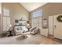 Cozy living room with high ceilings, large windows, and a neutral color palette for a relaxing ambiance at 8888 S Dudley St, Littleton, CO 80128