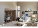 Bright living room boasts high ceilings, neutral tones, and an open layout to the dining area at 8888 S Dudley St, Littleton, CO 80128