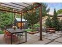 Outdoor living space with string lights, dining area, seating, and a fire pit at 14 S Grape St, Denver, CO 80246