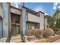 View of the building's exterior showing siding and the outdoor stairs at 11913 E Harvard Ave # 106, Aurora, CO 80014