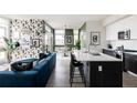 Open-concept living room with stylish decor, a kitchen island and plenty of natural light at 2880 Zuni St # 308, Denver, CO 80211