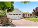 Home featuring an attached two-car garage and a wide driveway at 16308 E Wyoming Dr, Aurora, CO 80017