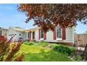 Well-maintained lawn and landscaping highlight this home with red shutters at 16308 E Wyoming Dr, Aurora, CO 80017
