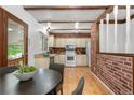 Cozy kitchen with rustic brick accents, wood beams, and ample cabinetry for storage at 16308 E Wyoming Dr, Aurora, CO 80017
