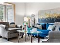 Bright living room features modern furniture, stylish decor, and a bay window providing natural light at 16308 E Wyoming Dr, Aurora, CO 80017