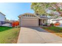 A beautiful home with a stone facade, two-car garage and lovely landscaping in a suburban neighborhood at 16553 Gilpin St, Thornton, CO 80602