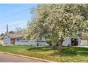 Charming single-story home featuring a well-maintained lawn and a freshly painted gray exterior at 7155 E Exposition Ave, Denver, CO 80224
