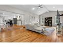 Open concept living room with hardwood floors seamlessly flows into the modern kitchen at 7155 E Exposition Ave, Denver, CO 80224