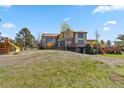Two-story home with mature landscaping and a playset in the front yard, offering a Gathering-friendly appeal at 7388 S Ireland Cir, Centennial, CO 80016