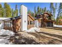 Exterior view showcasing the unique architecture and surrounding trees at 209 American Way, Breckenridge, CO 80424