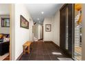 Inviting foyer with dark tile floor, wood accents and artwork at 209 American Way, Breckenridge, CO 80424