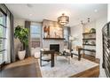 Elegant living room with fireplace, stylish furnishings, and natural light from large windows at 424 Grape St, Denver, CO 80220