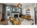 Cozy living room with a fireplace, stylish decor, comfortable seating arrangement, and abundant natural light at 424 Grape St, Denver, CO 80220