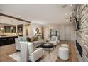 Inviting living space with stone accent wall and fireplace open to kitchen and dinning area at 424 Grape St, Denver, CO 80220