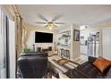 Open living area with bar seating and view into updated kitchen at 12354 W Nevada Pl # 102, Lakewood, CO 80228