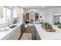 Modern kitchen with sleek stainless steel appliances, an island, and an open floor plan to the living room at 6526 S Cherry Way, Centennial, CO 80121