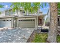 Charming front exterior showcasing a two-story townhome with a two car garage and well-maintained lawn at 9316 Harrison St, Thornton, CO 80229