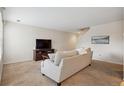 Cozy living room showcasing neutral walls and plush carpeting, creating a relaxing atmosphere at 9316 Harrison St, Thornton, CO 80229