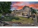 Spacious backyard with a patio, lush lawn, and privacy fence, perfect for outdoor entertaining at 18647 E Berry Dr, Aurora, CO 80015