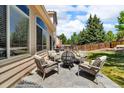 Relaxing backyard patio with comfortable seating and a cozy fire pit, ideal for gatherings at 18647 E Berry Dr, Aurora, CO 80015