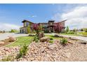 Beautiful home showcasing a landscaped front yard with decorative rock and lush greenery, offering great curb appeal at 2466 Spruce Meadows Dr, Broomfield, CO 80023