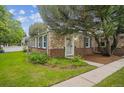 Cozy single-story brick home featuring a lush lawn and tidy curb appeal at 1279 Leyden St, Denver, CO 80220