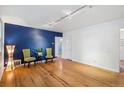 Bright living room with hardwood floors and stylish accent wall at 1279 Leyden St, Denver, CO 80220