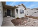 Inviting front porch with decorative plants and stone accents, leading to a modern front door at 1457 Rosedale St, Castle Rock, CO 80104
