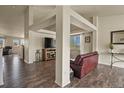 Open-concept living area with wood floors, providing ample space for relaxing and entertaining at 1457 Rosedale St, Castle Rock, CO 80104