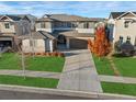 An aerial perspective of a home showcasing its layout, green lawn, and proximity to neighboring houses at 515 Orion Ave, Erie, CO 80516