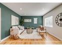 Bright living room with hardwood floors, stylish furnishings, and a large window at 1060 Grove St, Denver, CO 80204