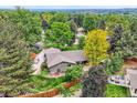 Overhead view of a secluded property surrounded by mature trees and landscaping at 2473 S Carr Ct, Lakewood, CO 80227