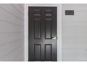Apartment door featuring unit number, located on light gray building exterior at 15700 E Jamison Dr # 305, Englewood, CO 80112