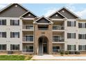 Charming condo complex with balconies, brick accents, and well-maintained landscaping at 15700 E Jamison Dr # 305, Englewood, CO 80112