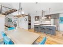 Open kitchen featuring stainless steel appliances, island with bar seating, and modern lighting fixtures at 3207 W 25Th Ave, Denver, CO 80211