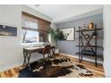 Inviting home office with a desk, accent wall, and natural light from a large window at 3207 W 25Th Ave, Denver, CO 80211