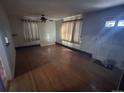 Bright living room featuring hardwood floors and a ceiling fan at 701 S Pecos St, Denver, CO 80223