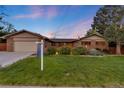 Inviting brick home with well-manicured lawn and landscaped garden beds, showcasing a serene and welcoming curb appeal at 92 S Devinney St, Golden, CO 80401